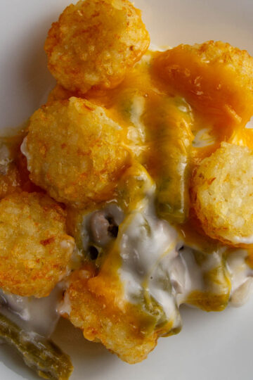 Easy Tater Tot Casserole a white plate with a serving of easy tater tot casserole