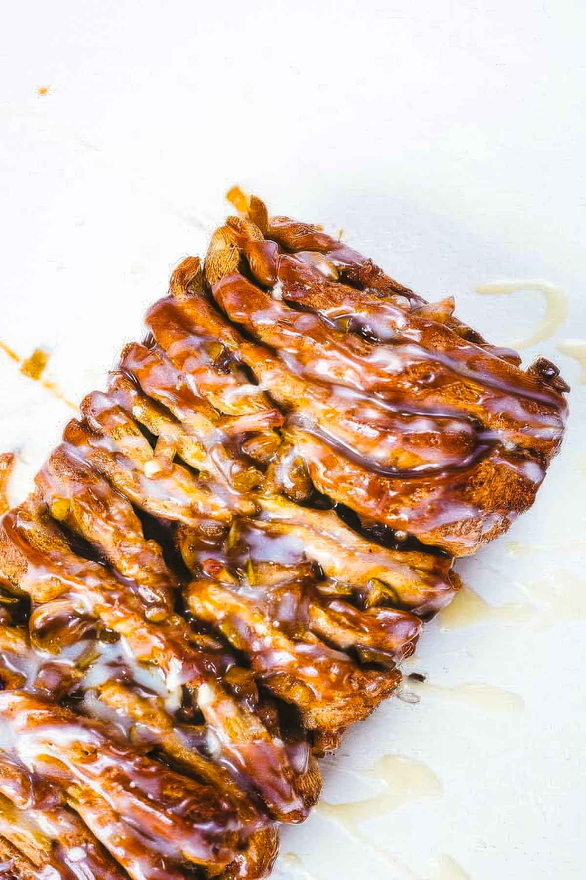 a loaf of apple pull-apart bread just out of the oven on a white surface