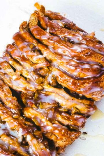 a loaf of pull apart apple monkey bread just out of the oven on a white surface