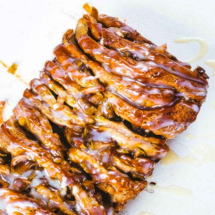 a loaf of pull apart apple monkey bread just out of the oven on a white surface