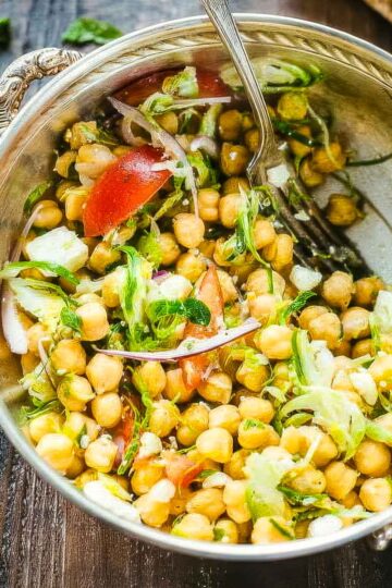 an overhead shot of chickpea feta salad in a vintage metal bowl