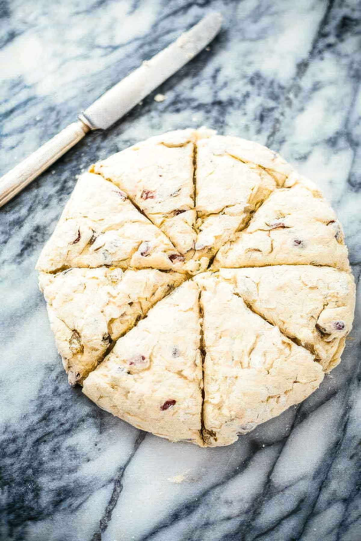 Irish Soda Bread Scones with Cinnamon Honey Butter step 6: irish soda bread scones on a marble countertop freshly scored and ready for the oven