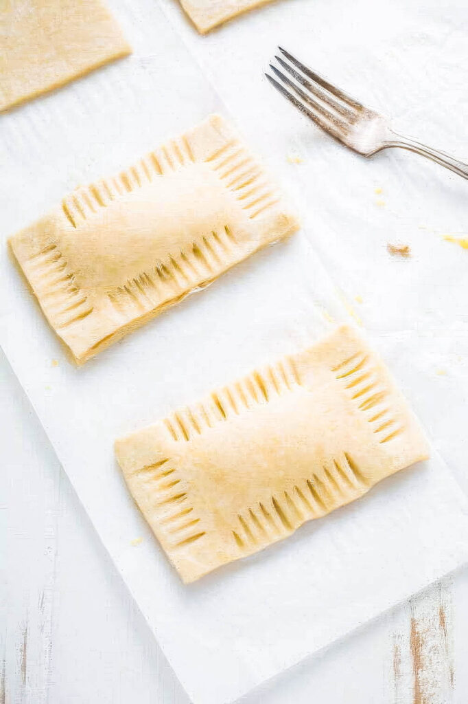 Homemade Peanut Butter Pop Tarts a second image of step 13 for making homemade pop tarts showing the edges being crimped with a fork