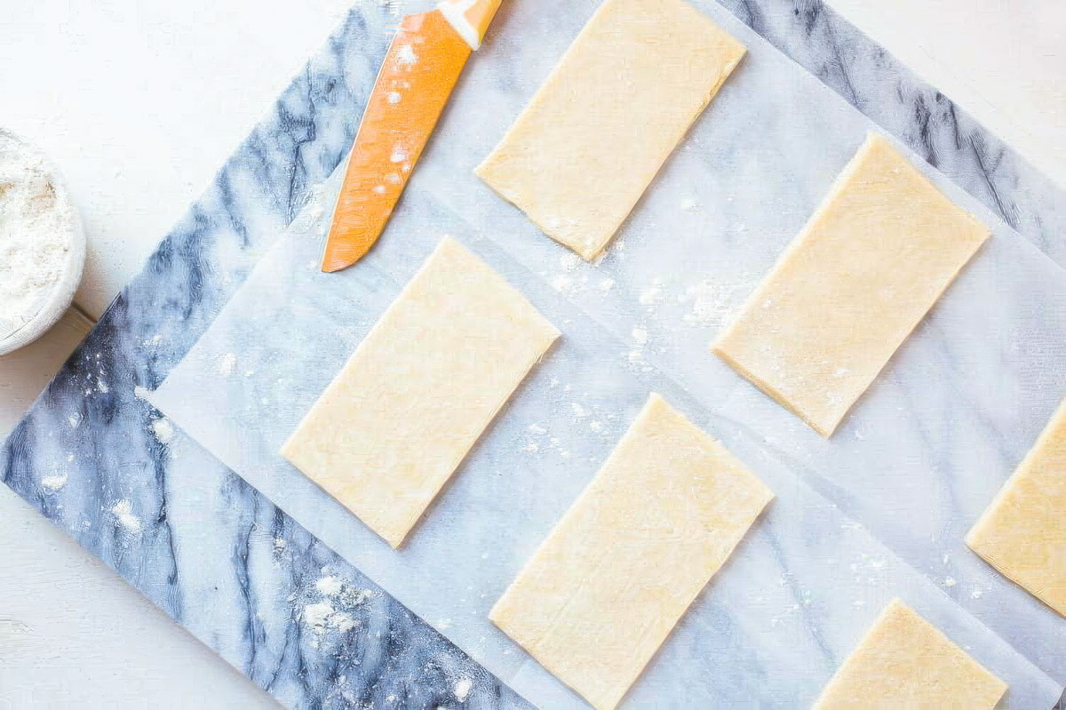 Homemade Peanut Butter Pop Tarts homemade pop tart dough on parchment paper after being cut into 9 pieces