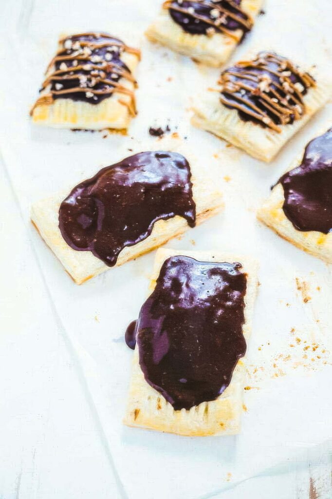 Homemade Peanut Butter Pop Tarts step 15 for making peanut butter pop tarts showing the glaze spread onto the hot pop tarts