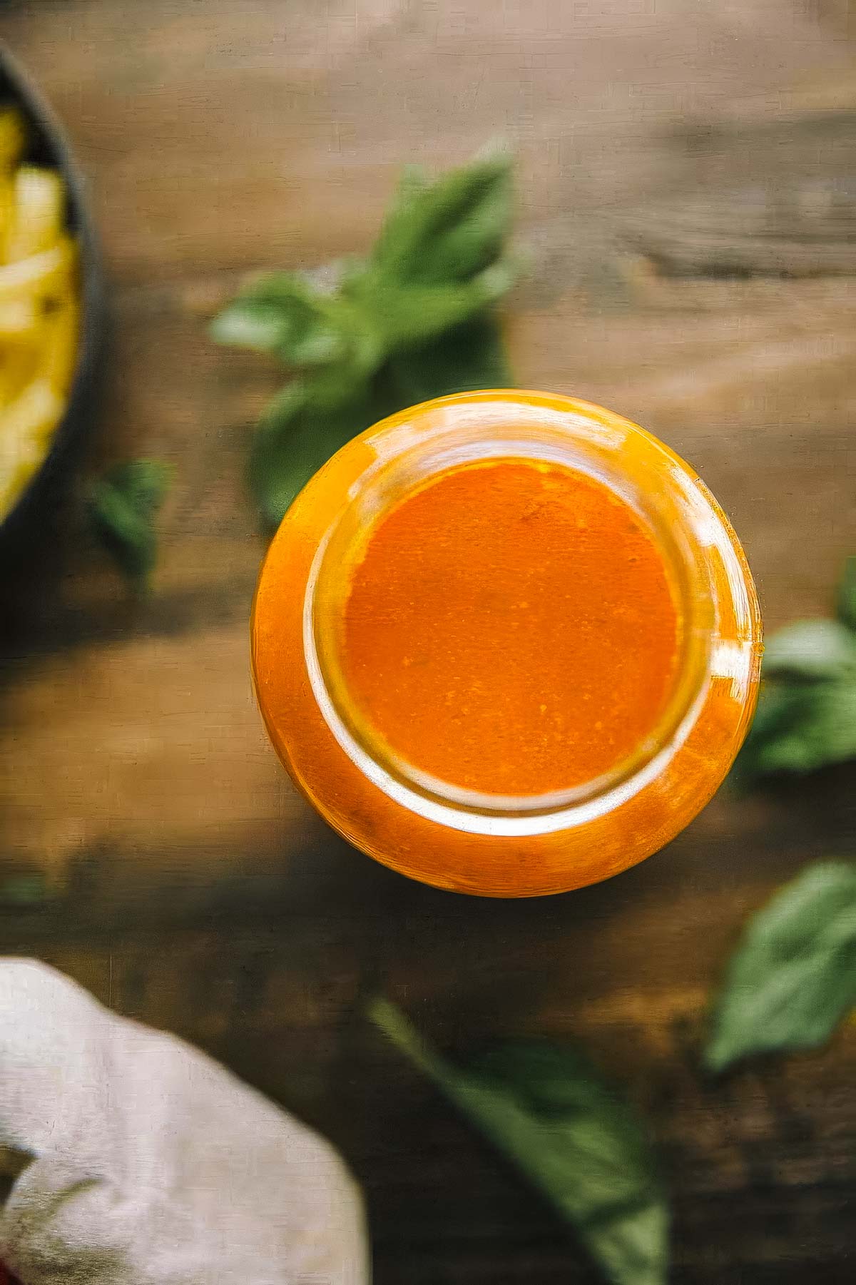 Authentic Italian Marinara Sauce a jar of authentic italian marinara sauce with fresh basil on the table