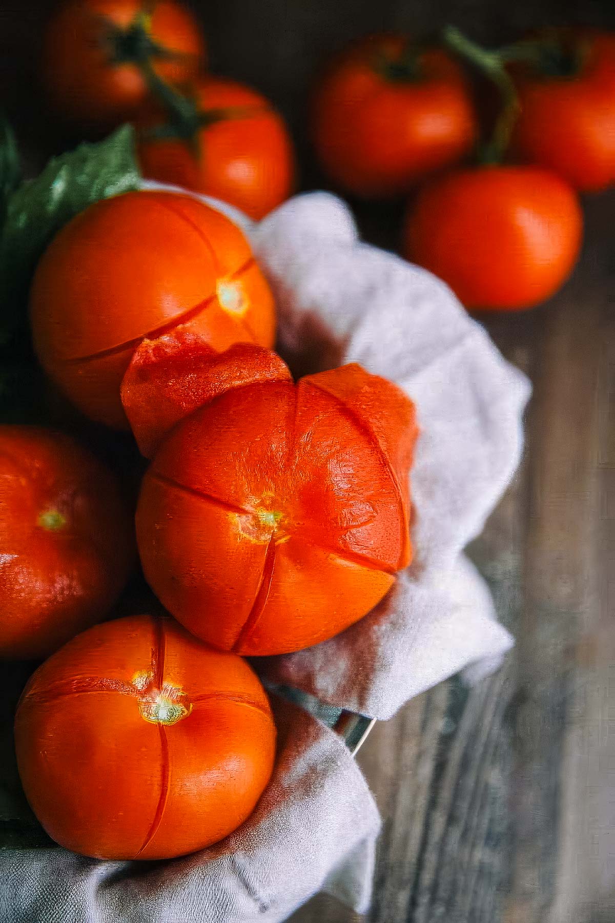 Authentic Italian Marinara Sauce a basket of scored and peeled fresh tomatoes