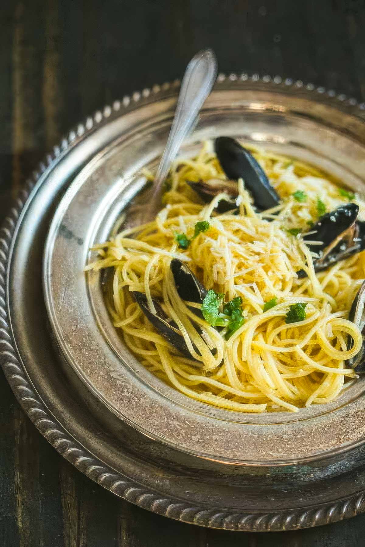 overhead shot of Mussels carbonara on a vintage plate with a fork