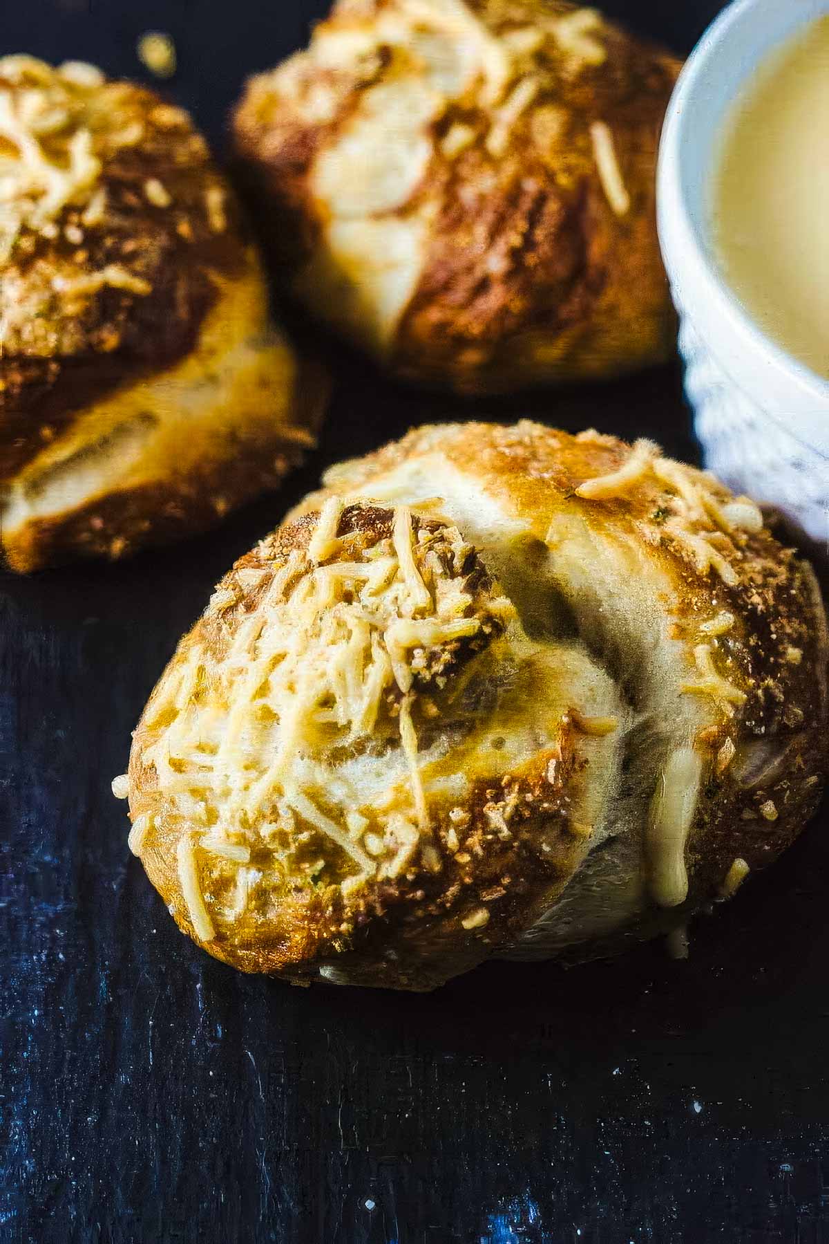 Garlic Pretzel Knots with Cheese Dipping Sauce a closeup of a garlic pretzel knot as it cools