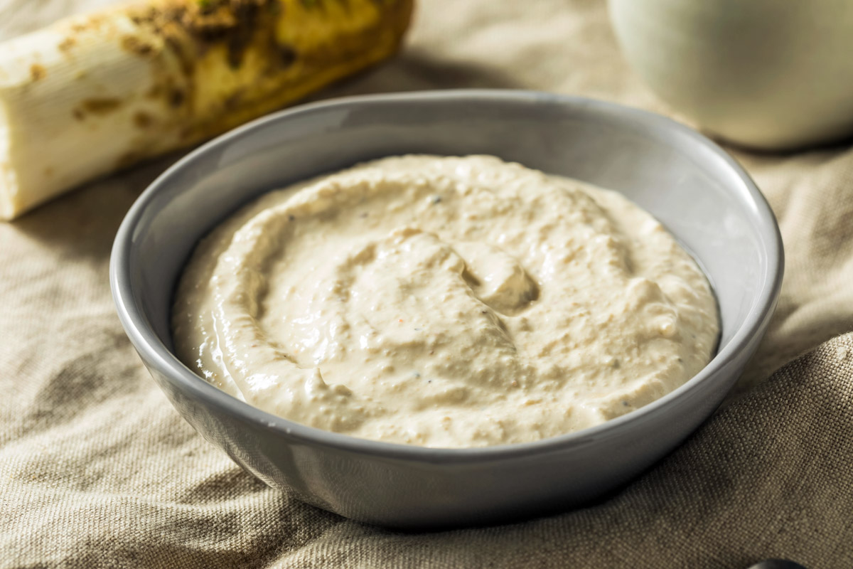 Horseradish Sauce For Prime Rib a gray bowl filled with horseradish sauce on a beige napkin